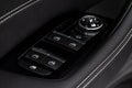 Close up view of button controlling window in modern car interior. Vehicle interior detail. Door handle with windows controls. Royalty Free Stock Photo