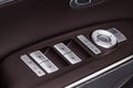 Close up view of button controlling window in modern car interior. Royalty Free Stock Photo