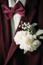 close up view of buttonhole and grooms suit with bow tie Royalty Free Stock Photo