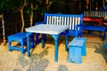 close-up view of cafe benches on the beach sand.