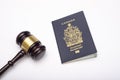 Close up view of canadian passport and Judge gavel, immigration law