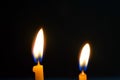 Close up view of the candles burning brightly in the dark. Royalty Free Stock Photo