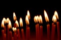 Close up view of the candles burning brightly in the dark. Royalty Free Stock Photo