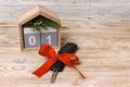 Close-up view of car keys with red bow as present and calendar on wooden background on wooden background Royalty Free Stock Photo