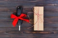 Close-up view of car keys with red bow as present on wooden background Royalty Free Stock Photo