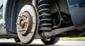 Close up view of a car's front brake rotor and suspension system during maintenance Royalty Free Stock Photo