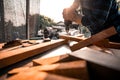 Close-up view A carpenter using a drilling tool or an electric screwdriver is working at home on the wooden floor. Ideas for home Royalty Free Stock Photo