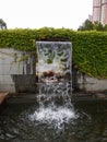 Close-up view of a cascading feature water fountain in a public park. Royalty Free Stock Photo