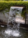 Close-up view of a cascading feature water fountain in a public park. Royalty Free Stock Photo