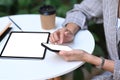 Casual businesswoman sitting in cafe and using digital tablet and mobile phone. Royalty Free Stock Photo