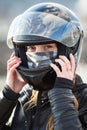 Close up view at Caucasian woman motorcyclist wearing crash black helmet on head