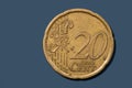 Close up view of 20 cent euro coin on blue background Royalty Free Stock Photo