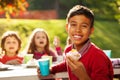 Close up view of Central Asian boy holding cupcake Royalty Free Stock Photo