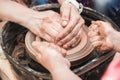 A close up view on ceramic production process on potter`s wheel with children. Clay crafts with kids concept Royalty Free Stock Photo