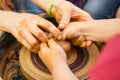 A close up view on ceramic production process on potter`s wheel with children. Clay crafts with kids concept Royalty Free Stock Photo