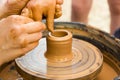 A close up view on ceramic production process on potter`s wheel with children. Clay crafts with kids concept Royalty Free Stock Photo