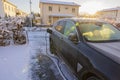 Close up view of charging electric car covered in snow in private parking lot on winter day. Royalty Free Stock Photo