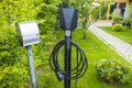 Close up view of charging station for electric car in front yard of townhouse. Royalty Free Stock Photo