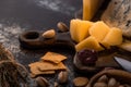 Close up view of cheese platter with knife, pistachios, olives and crackers Royalty Free Stock Photo