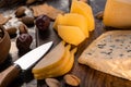 Close up view of cheese platter with knife, sliced pear, pistachios, olives and crackers Royalty Free Stock Photo