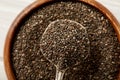 close up view of chia seeds in spoon and wooden bowl Royalty Free Stock Photo