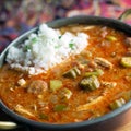 Close up view of chicken and Andouille sausage gumbo with a scoop of rice. Royalty Free Stock Photo