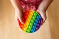 Close up view of child play with rainbow color push pop bubble sensory fidget toy. Royalty Free Stock Photo