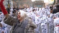 Close-up view of children in Dalmatian costumes and greasepaint dancing on the street during carnival. Art. Carnival Royalty Free Stock Photo