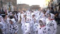 Close-up view of children in Dalmatian costumes and greasepaint dancing on the street during carnival. Art. Carnival Royalty Free Stock Photo