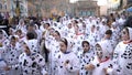 Close-up view of children in Dalmatian costumes and greasepaint dancing on the street during carnival. Art. Carnival Royalty Free Stock Photo