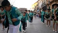 Close-up view of children in green and black carnival costumes dancing on the street during carnival. Art. Carnival Royalty Free Stock Photo