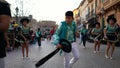 Close-up view of children in green and black carnival costumes dancing on the street during carnival. Art. Carnival Royalty Free Stock Photo