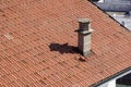 A close up view of a chimney on top of red roof tiles Royalty Free Stock Photo