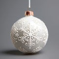 Close up view of Christmas ball with relief snowflakes. Decoration bauble isolated grey background. Minimalist design of Christmas Royalty Free Stock Photo