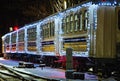 Close-up view of Christmas decorated train by lights. Train arrived at the station