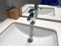 Close up view of a chrome basin tap and sink Royalty Free Stock Photo