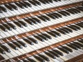 Close up view of a church pipe organ with four keyboards