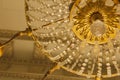 Close up view of a circular vintage glass and gold metal light fixture