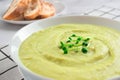 Close up view of classic french chilled cream soup vichyssoise - potato leek soup topped with microgreens in white bowl