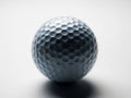 A close-up view of a classic golf ball showcasing its dimpled surface under monochromatic lighting Royalty Free Stock Photo