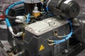 Close up view on clean new air compressor with electric motor, filter, rubber hoses, pneumatic and hydraulic components. Turbo com Royalty Free Stock Photo