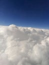 Close-up view of clouds from an airplane window against a blue sky Royalty Free Stock Photo