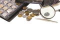 Close up view of collection of ancient coins with magnifying glass, tweezers and albums.