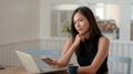 Close up view of college girl thinking about her assignment while using smartphone Royalty Free Stock Photo