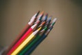 Close up view of color pencils in hand on wooden background. Selective focus. Royalty Free Stock Photo