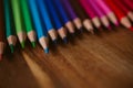 Close up view of colored pencils on wooden background. Back to school and education concept. u Royalty Free Stock Photo