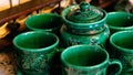 Close up view of colorful artisanal ceramic tea cups and teapot pottery handcrafted