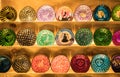 Close-up view of the colorful handicraft bowls selling in the souvenirs stall at Ratchada Rot Fai Train Night Market Bangkok