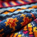 Close-up view of colorful and intricate crocheted blanket. It is made up of various colors, including blue, yellow Royalty Free Stock Photo