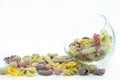 Close-up view of the colorful macaroni  in glass bowl isolated on the white background Royalty Free Stock Photo